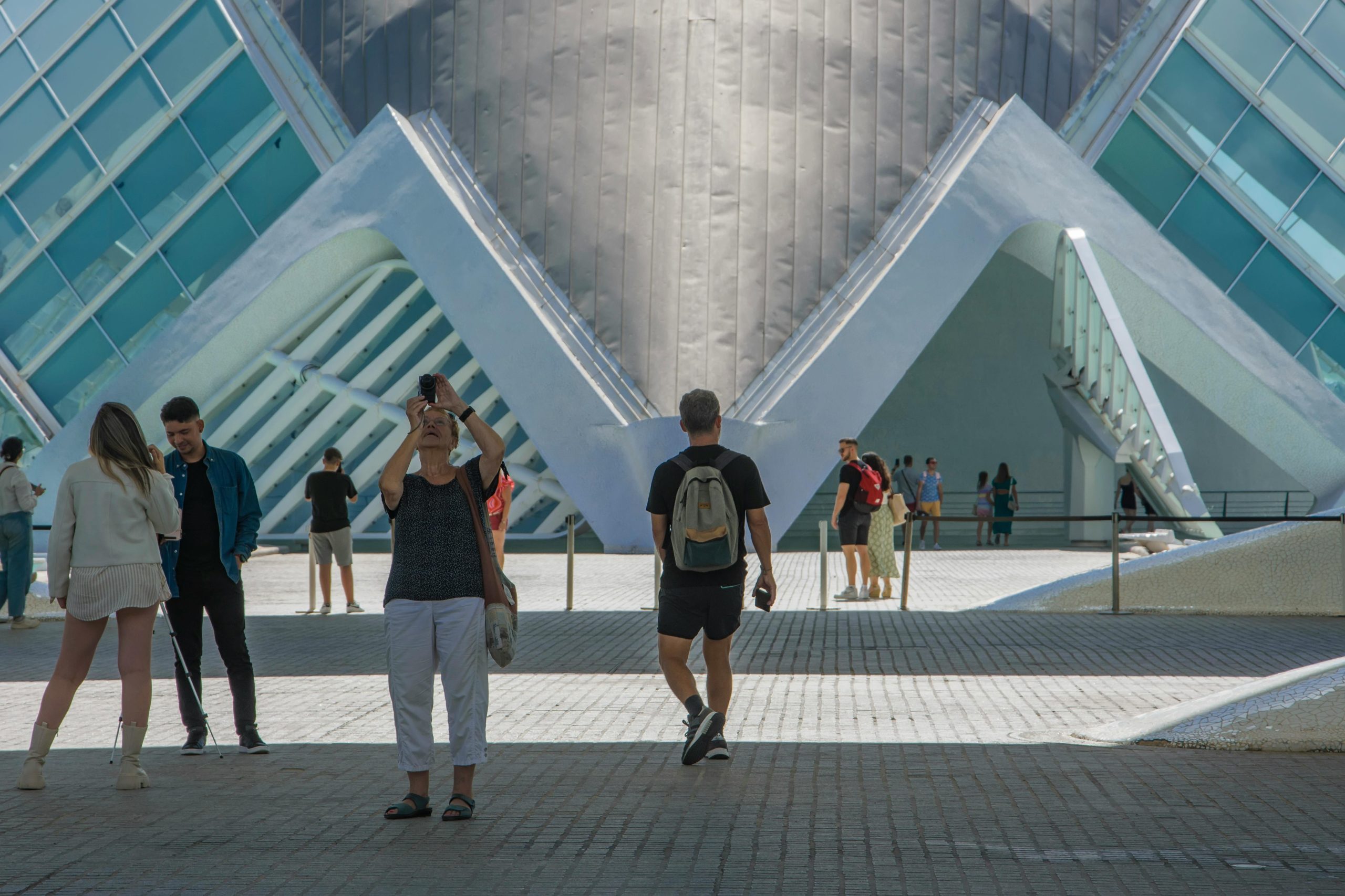Visitors explore the modern architecture of the City of Arts and Sciences in Valencia, Spain.